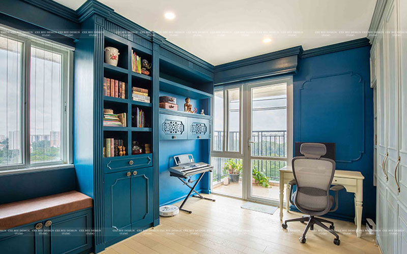 Cozy blue home office featuring a desk and bookshelf for productivity.