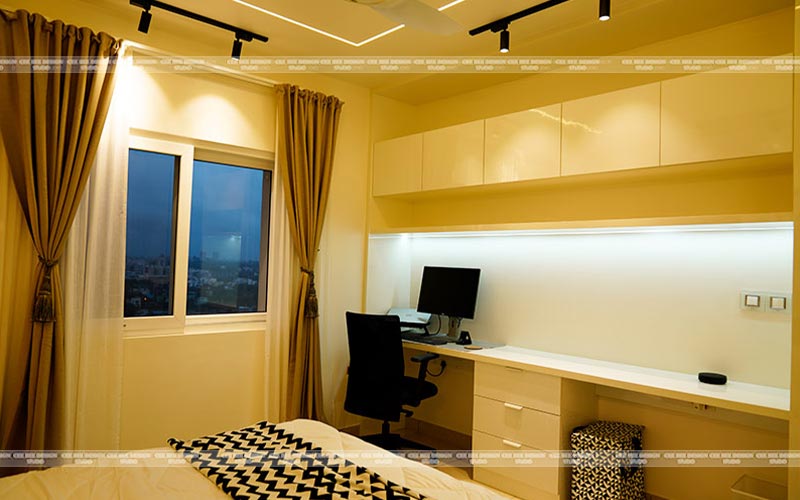 a well-lit bedroom featuring a desk and a window, creating a serene and productive atmosphere