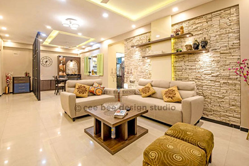 Interior of a living room featuring a couch, coffee table, and chairs.