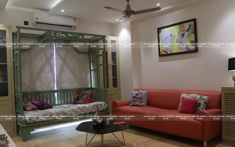 bohemian interior design living room with red sofa and table in the middle and green sitting stand