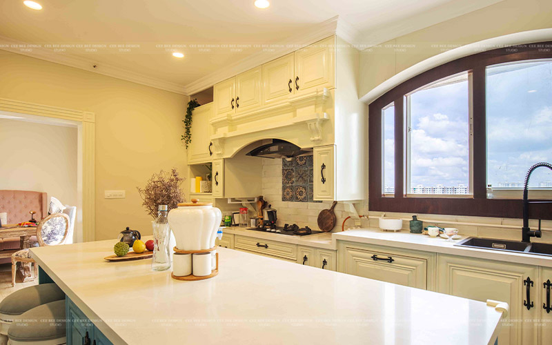 classic white modular kitchen with window and open sky dining table and fruits