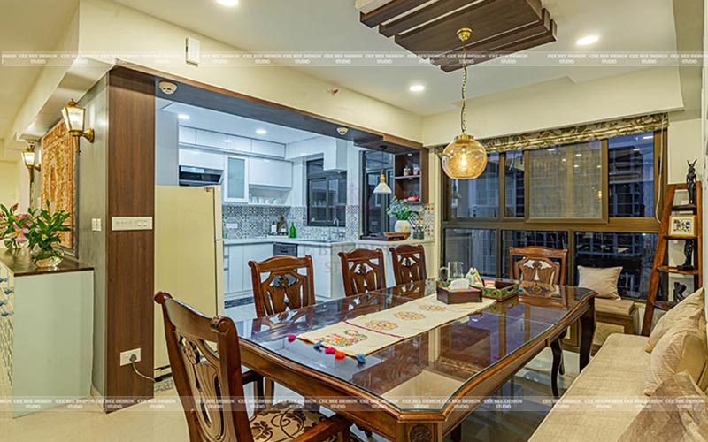 dining room with hanging light and kitchen beside with big window