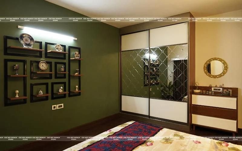 green wall with reflecting wardrobe and wooden floor with carpet
