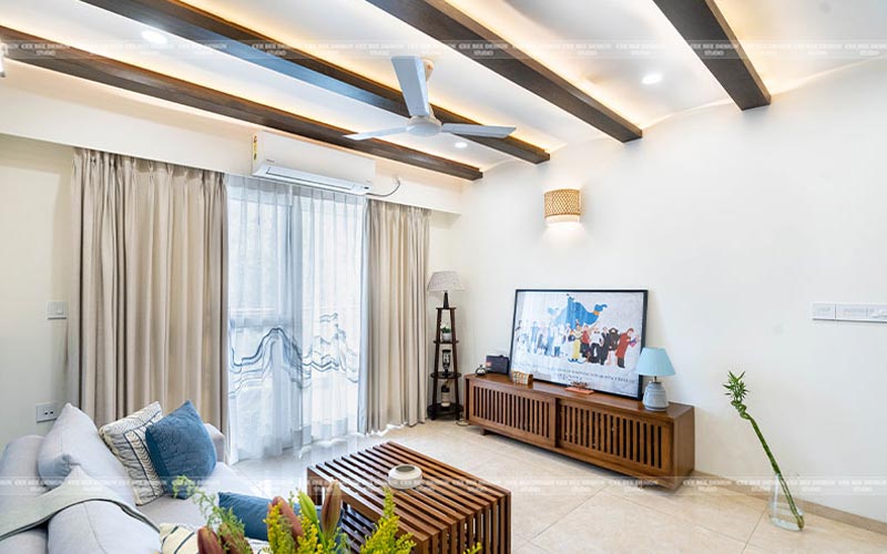 A cozy living room with a ceiling fan and a television.