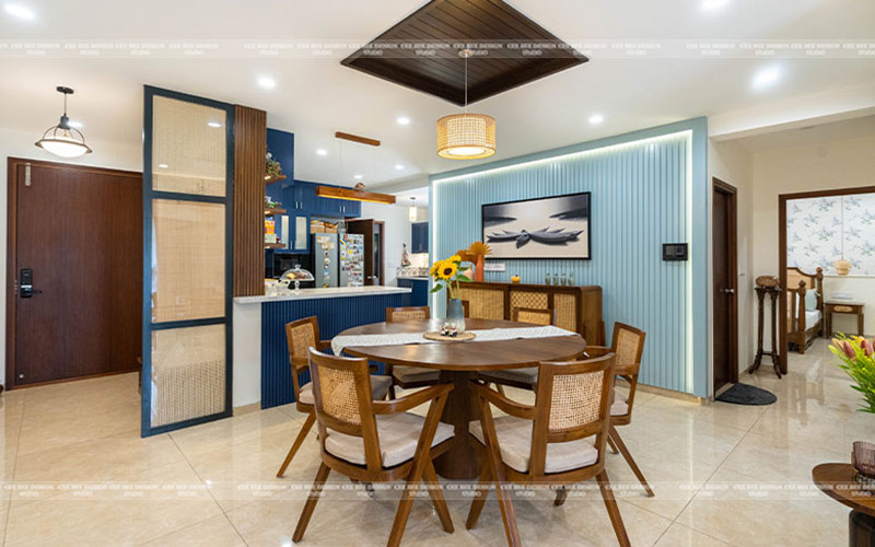 a contemporary dining room with blue walls and wooden furniture