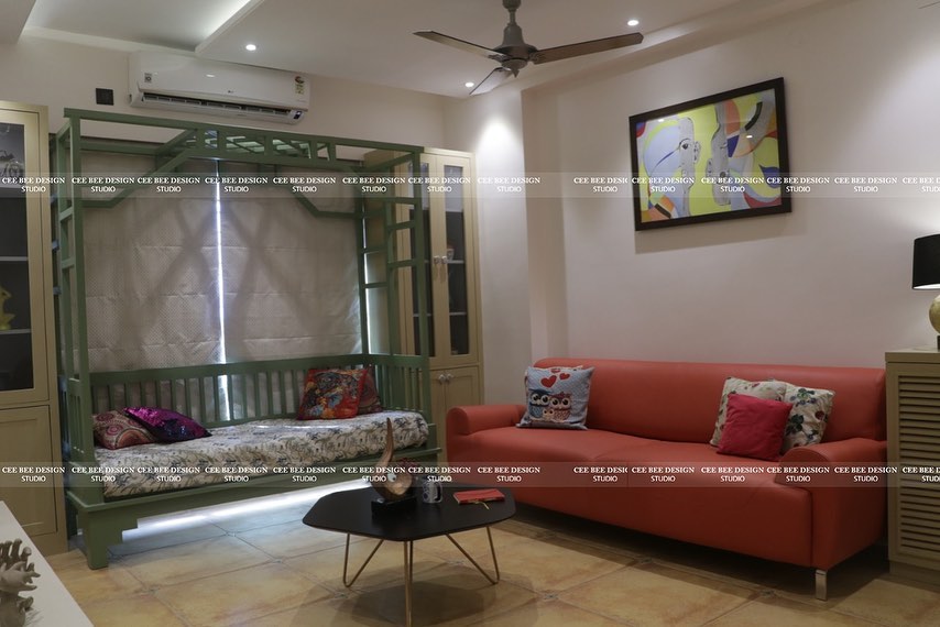 a vibrant living room with red furniture and a comfortable couch