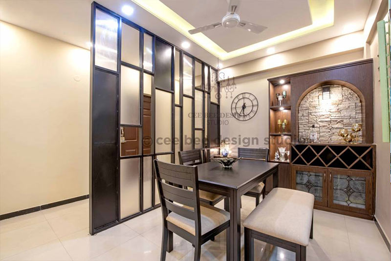 A dining room with a wooden table and four chairs.