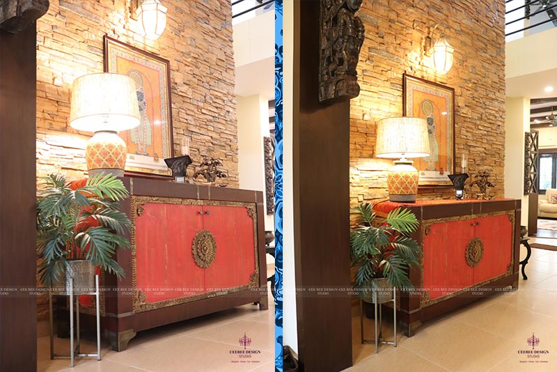 Two pictures of a living room with a red and gold cabinet.