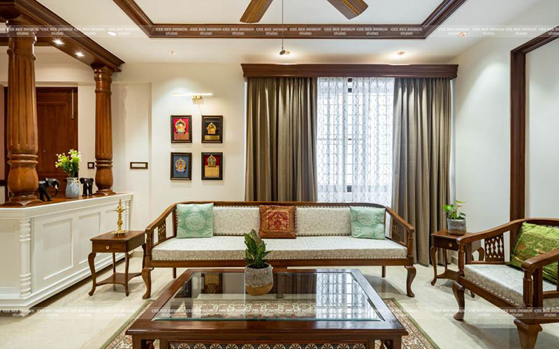 Living room with wooden furniture and ceiling fan in turnkey interior design.