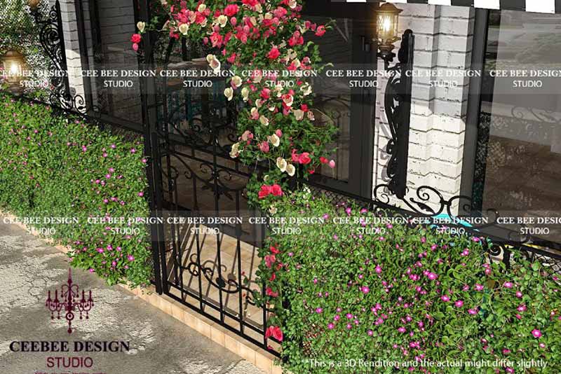 a black wrought iron gate adorned with vibrant flowers and lush plants.