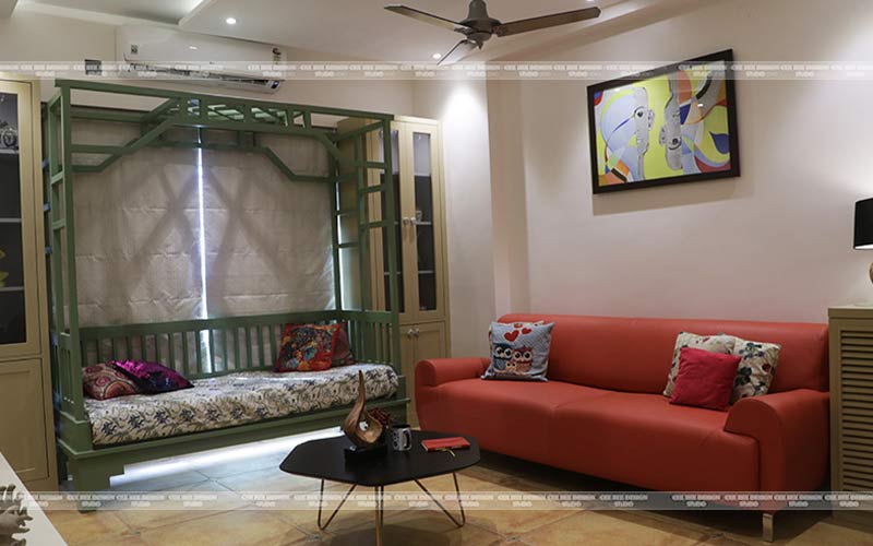 A cozy living room with a couch, coffee table, and a painting on the wall.