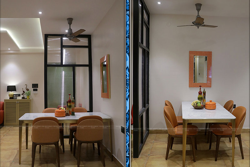 Dining room and kitchen with a ceiling fan in a cozy setting.