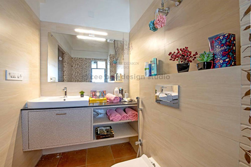 A bathroom with a toilet, sink, and mirror.