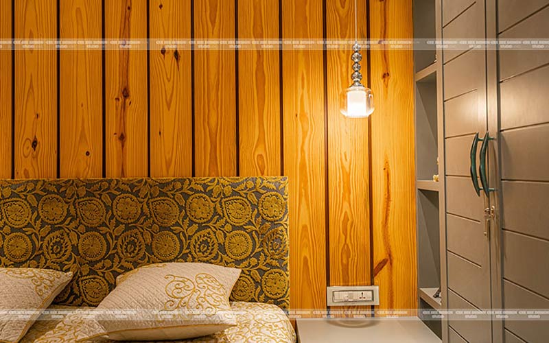 Bed with yellow and white pillow with wooden texture background creating a cozy and inviting atmosphere.