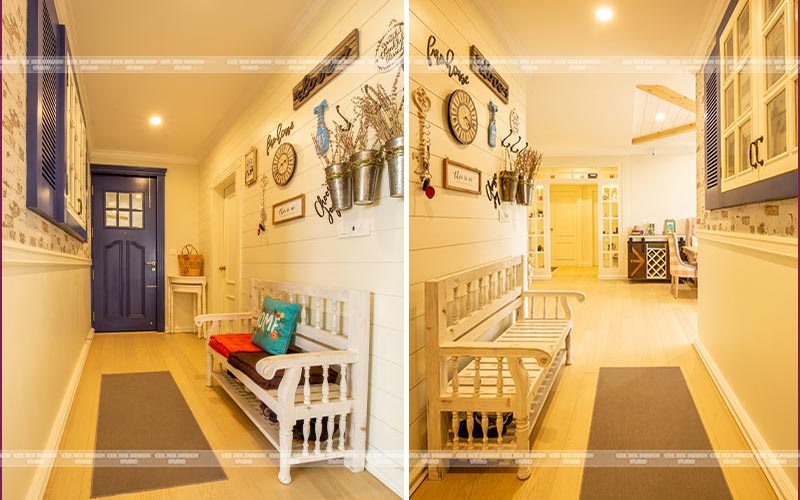 english country style hallway with a wall decor and bench and a door