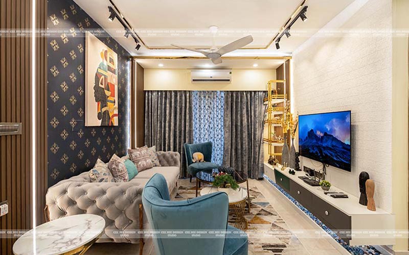 Interior of a living room featuring a blue couch and a television.