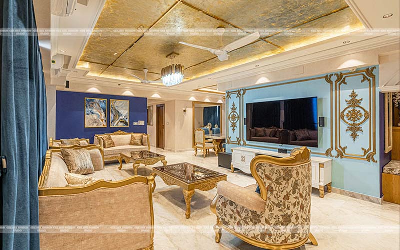 A living room with elegant gold and blue decor, creating a luxurious and sophisticated ambiance.