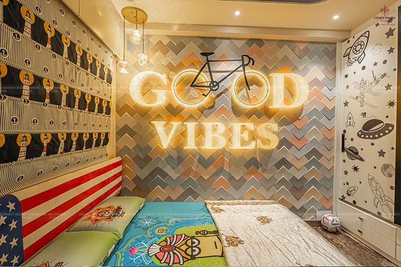 A luxurious 3bhk bedroom with a cozy bed, a wall adorned with a Good Vibes sign, and a stylish cycle hanging.