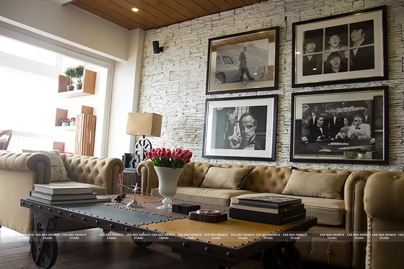 A well-decorated living room with a couch, coffee table, and wall art.