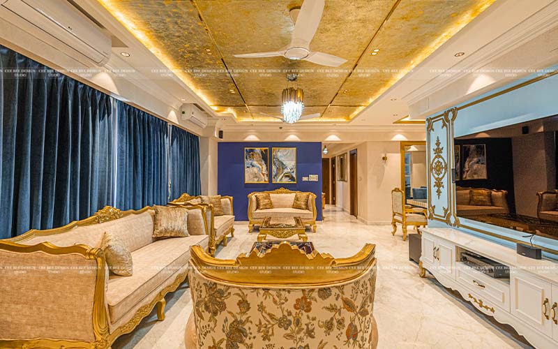 luxury living area with golden vibe sofa and ceiling and blue velvet curtains