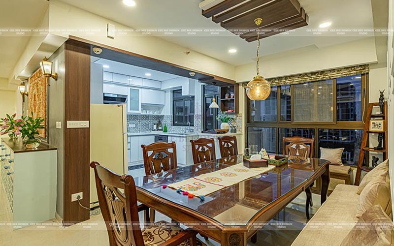 modern dining area with dining table and chairs with pot ceiling light and modular kitchen in the left