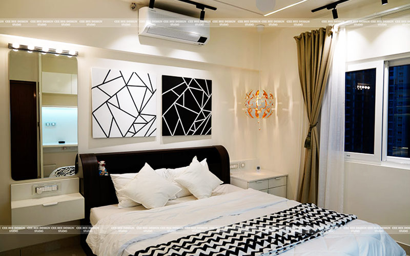 a cozy bedroom with a comfortable bed a stylish mirror and an elegant painting on the wall