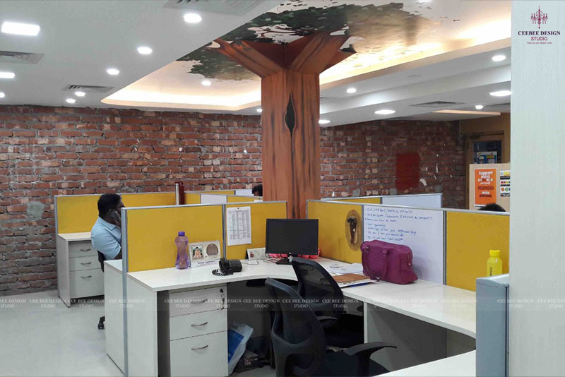 office design with artificial tree between the working floor and cabinets computers