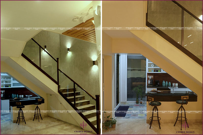 image of a stairway leading to a kitchen with potted plants and chairs